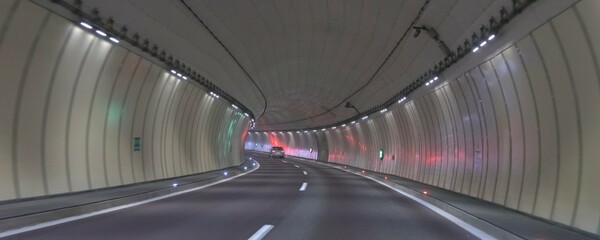 Little traffic in a motorway tunnel on the Brenner Pass with new colored road boundaries and new LED lighting