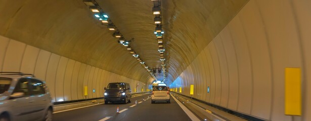 Little traffic in a motorway tunnel on the Brenner Pass with new colored road boundaries and new LED lighting