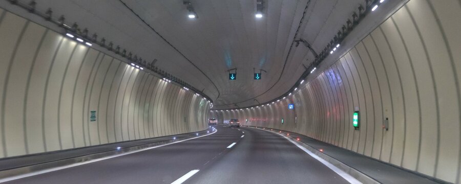 Little traffic in a motorway tunnel on the Brenner Pass with new colored road boundaries and new LED lighting