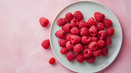 Ripe raspberries on a white plate 