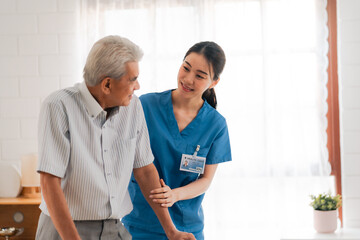 Asian physiotherapist nursing home to support old senior man patient therapy by walker, caregiver nurse help recovery health care with elderly retirement man person at home, health insurance concept