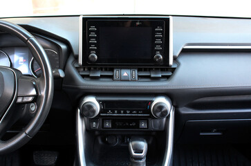Modern SUV dashboard. Screen multimedia system. Interior of a modern luxury car. Control panel in a...