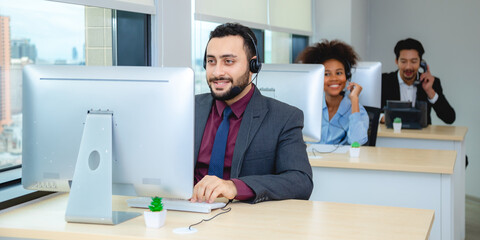 Obraz premium Customer service, call center or telemarketing team and manager or mentor looking happy reading online feedback or sale on website. Diversity people, support sales consultant training office