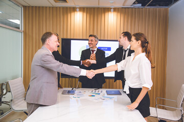 Fototapeta premium professional businessman person team meeting business partner for a deal agreements partnership job, using hand to make handshake with success teamwork, collaboration corporate work in office company