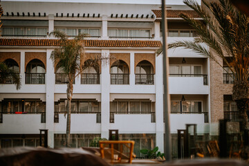 Agadir, Morocco - February 25, 2024 -  facade of a white multi-story building with balconies,...
