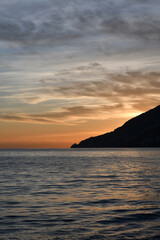 Naklejka na ściany i meble The sunset over a town on the Campania coast on the road to Amalfi.