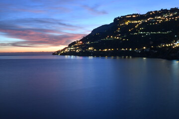 The sunset over a town on the Campania coast on the road to Amalfi.