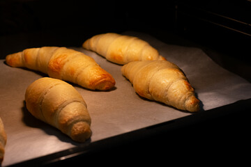 Croissants in the oven. Baking at home