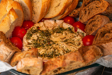 Baked Camembert cheese in sourdough bread with rosemary, garlic, thyme