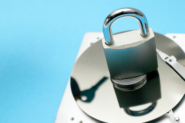 Data security concept. Cyber security concept with a padlock on hard disk. A disassembled hard...