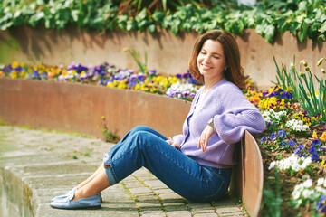 Seasonal spring portrait of beautiful happy woman relaxing outside, enjoying nice sunny day - 752174380