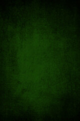 Abstract dark green rich background with grunge vignette with scratches and cracks.