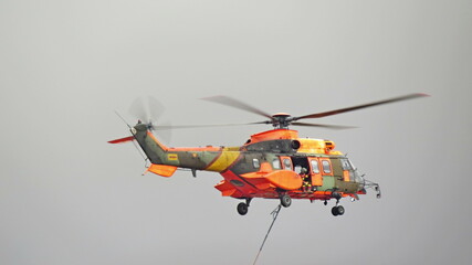 exhibition helicopter rescue orange base torrejon propellers background gray sky