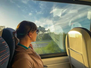 Poster Young commuter takes the train to work on a beautiful sunny weekday morning © helivideo