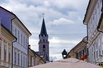 Old town of Slovenian City of Kranj at  Glavni town square with historic houses and church tower on...