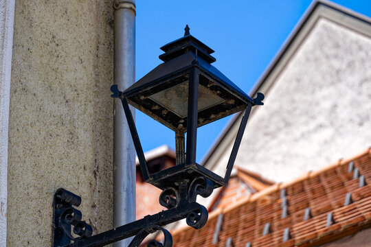 Old town of Slovenian City of Kranj with close-up of black lantern on a sunny summer day. Photo taken August 10th, 2023, Kranj, Slovenia.