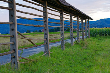 Idyllic close-up view of hayrack at farmland at village of Zabnica on a blue cloudy summer evening. Photo taken August 10th, 2023, Zabnica, Kranj, Slovenia.