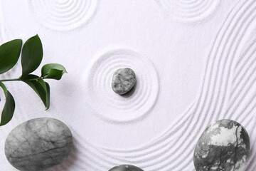 Zen concept. Stones, leaves and pattern on white sand, flat lay
