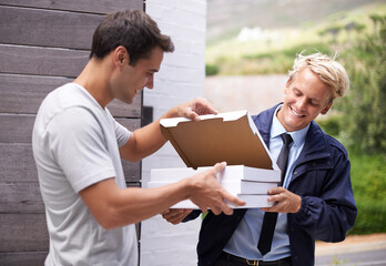 Men, delivery and giving pizza boxes to customer at gate, home and outdoor for service, fast food and meal. People, happy and together with cardboard package for order by garden at house in Cape Town