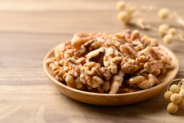Organic raw walnuts in wooden plate, Food ingredient