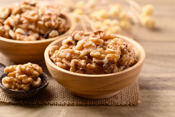 Organic raw walnuts in wooden bowl, Food ingredient