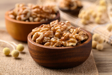 Organic raw walnuts in wooden bowl, Food ingredient