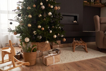 Christmas decor in domestic, cosy living room with christmas tree, wooden rocking chair, gifts, sledge, carpet. Background with copy space. Concept of Christmas, celebration, magic.