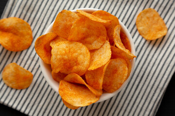 Paprika Potato Chips in a Bowl, top view. Flat lay, overhead, from above.
