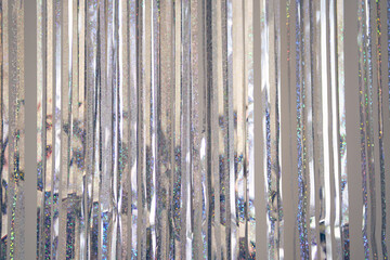 Silver fringe curtains party decoration with copy space. Metallic tinsel rain background. Concept of Christmas, party, wedding, birthday, event. 