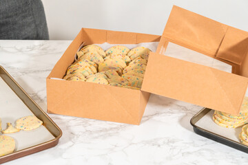 Packing Sprinkle-Adorned Sugar Cookies into Boxes
