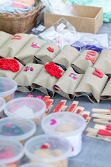 crafts on display for sale with plastic boxes and clothes pins