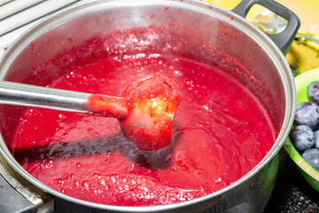 A pan of plum puree, whipped in a blender. Making jam, sweet fruit marmalade