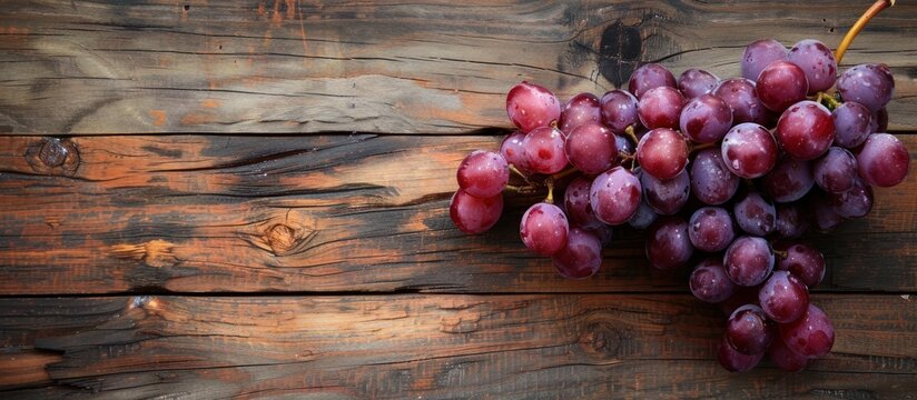 A bunch of grapes neatly arranged on top of a wooden table.