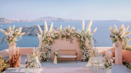 A scenic Santorini wedding backdrop in soft pastel pink, embellished with floral arrangements and decorative elements.