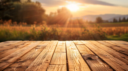 A wooden table top planks product display with a blurred background scene of farmland at sunset. - obrazy, fototapety, plakaty