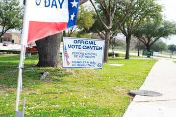Yard sign and vote banner flag show Official Vote Center in English, Spanish, Vietnamese to welcome...
