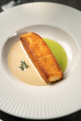 Baked salmon with sauce on white plate. Mediterranean diet concept.