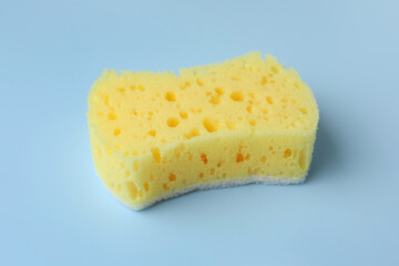 New yellow sponge on light blue background