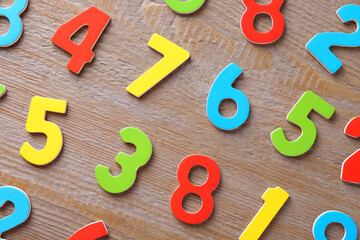 Colorful numbers on wooden table, flat lay