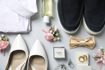Wedding stuff. Flat lay composition with stylish boutonniere on light gray background