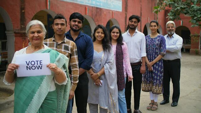 Active voters standing in a queue promoting everyone to vote during the elections - general elections  state elections  India  Indian voters. Responsible citizens of all age outside a polling booth...