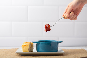 A tantalizing plate of chorizo cooked in wine, offering a rich blend of smoky flavors and savory aromas, perfect for sharing