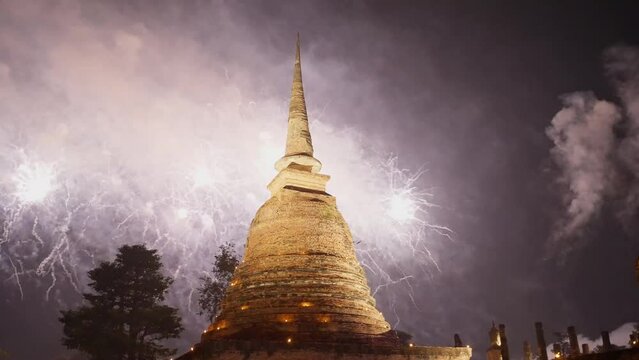 Beautiful fireworks celebration of Loy Krathong at Sukhothai Historical Park festival. Thai buddhist temple architecture at night. Loy Krathong at Sukhothai historical park , Sukhothai, Thailand