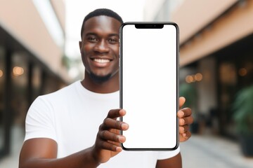 Portrait of african american guy holding big smartphone with white blank mock up screen