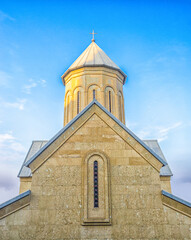 Fototapeta na wymiar Temple of the Georgian Orthodox Church on a background of blue sky