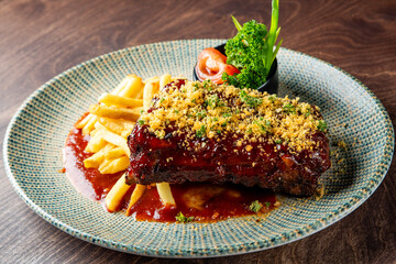 Pork ribs with french fries and sauce