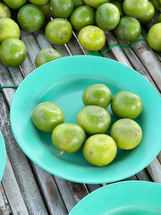 fresh green limes on green dish