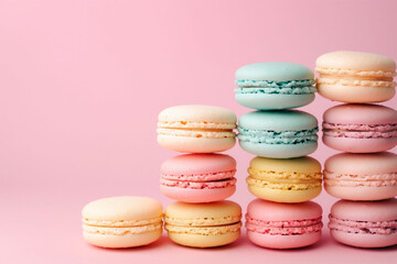 Fototapeta na wymiar Four columns of colorful macarons in pastel pink background, evoking a sweet, delicate charm. Perfect for confectionery marketing and dessert blogs