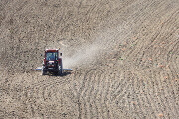 farmers plouging the field in spring