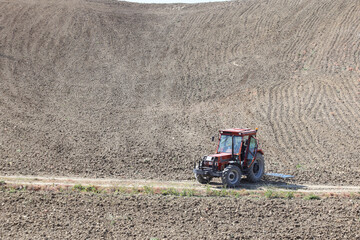 farmers plouging the field in spring